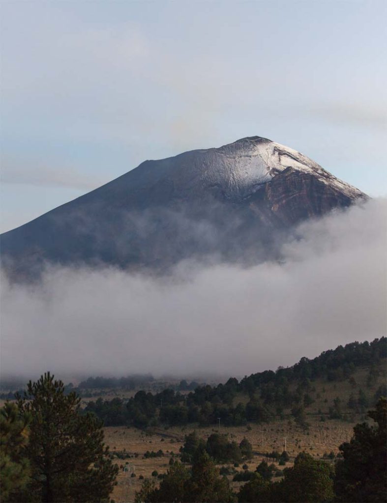 Volcano landscape in Mexico with clouds and forest view