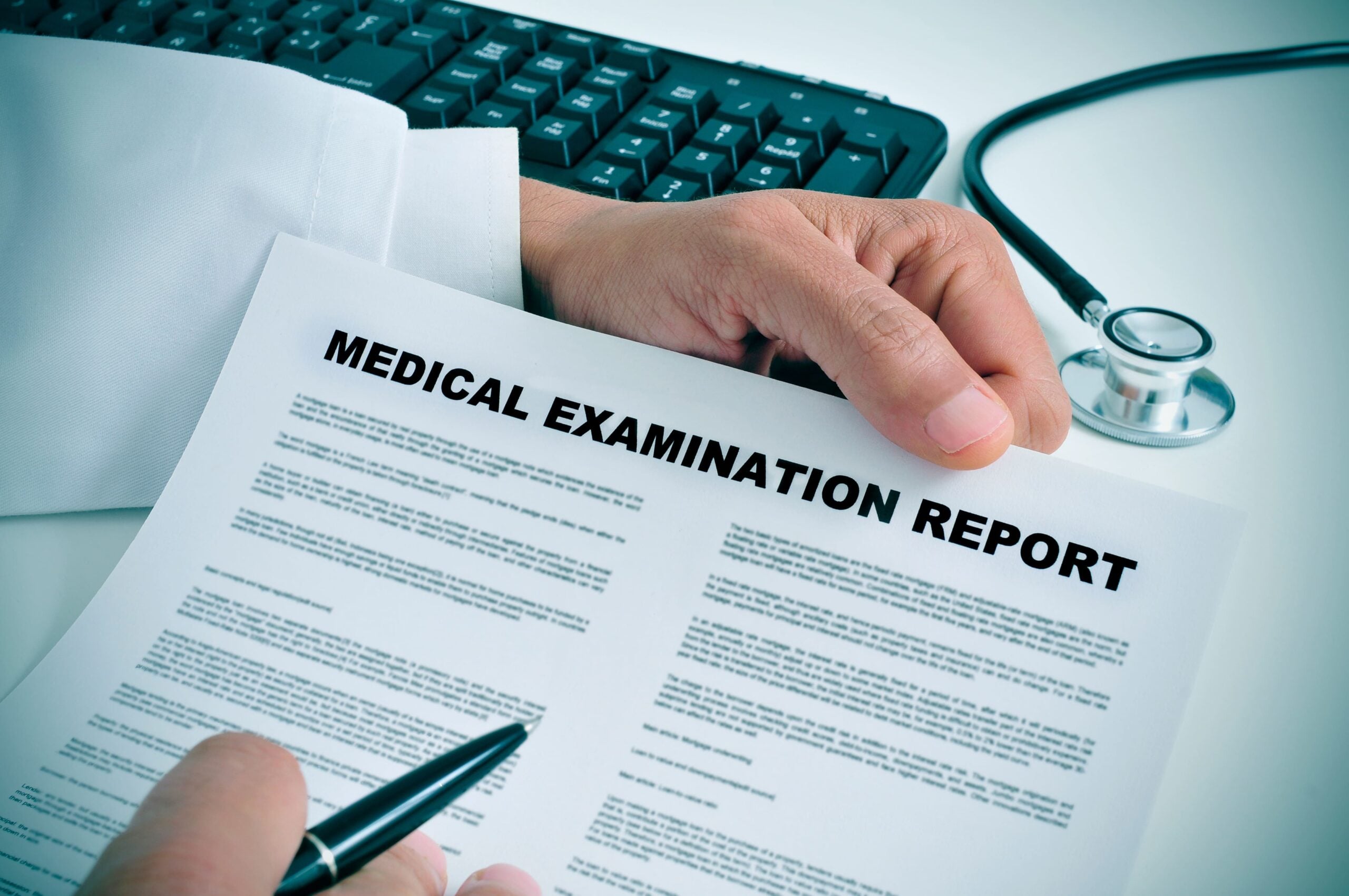 A medical report being analyzed by a person holding a pen