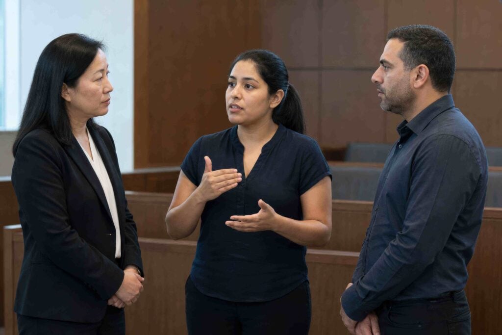 Interpreter facilitating communication between Korean-speaking participants in a legal setting