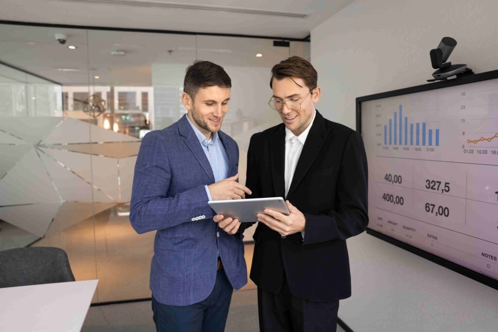 On-site interpretation for business meetings: two professionals review a tablet in a modern office