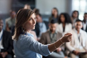 a businesswoman talking to an audience during a workshop