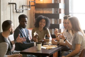 a group of friends having a conversation in a cafe